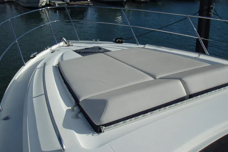 Slide: The Image of 2015 Princess V48 yacht with sunbathing area on deck, docked at marina. - 8