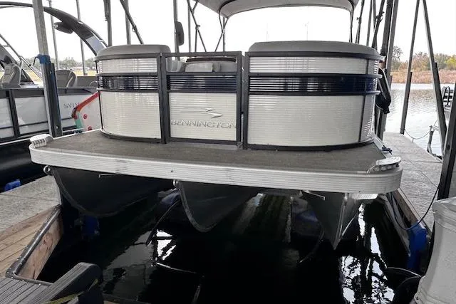 Slide: The Image of 2023 Bennington SX 21 Fishing pontoon boat docked in a marina. - 12