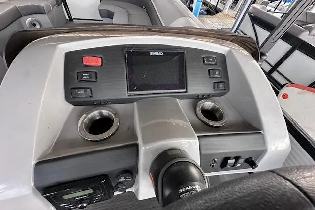 Slide: The Image of 2023 Bennington SX 21 Fishing boat dashboard with Simrad display and cup holders. - 13