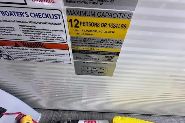 Slide: The Image of 2023 Bennington SX 21 Fishing boat capacity label, 12 persons or 1624 lbs, safety instructions. - 15