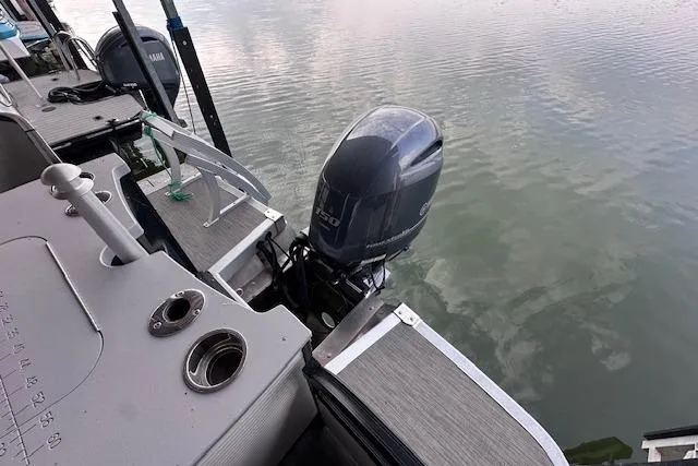 Slide: The Image of 2023 Bennington SX 21 Fishing boat with Yamaha outboard motor on calm water. - 8