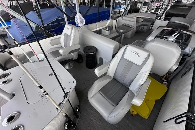 Slide: The Image of 2023 Bennington SX 21 Fishing boat interior with seating and fishing rods. - 9