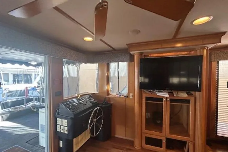 Slide: The Image of 2007 Sumerset Lakeview HD interior with helm, TV, and wooden cabinetry. - 10
