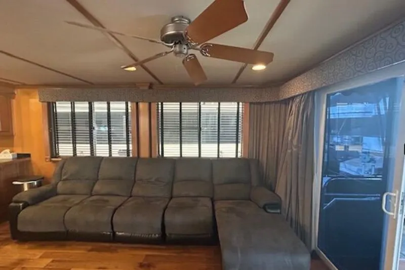 Slide: The Image of 2007 Sumerset Lakeview HD interior with gray sectional sofa and ceiling fan. - 13