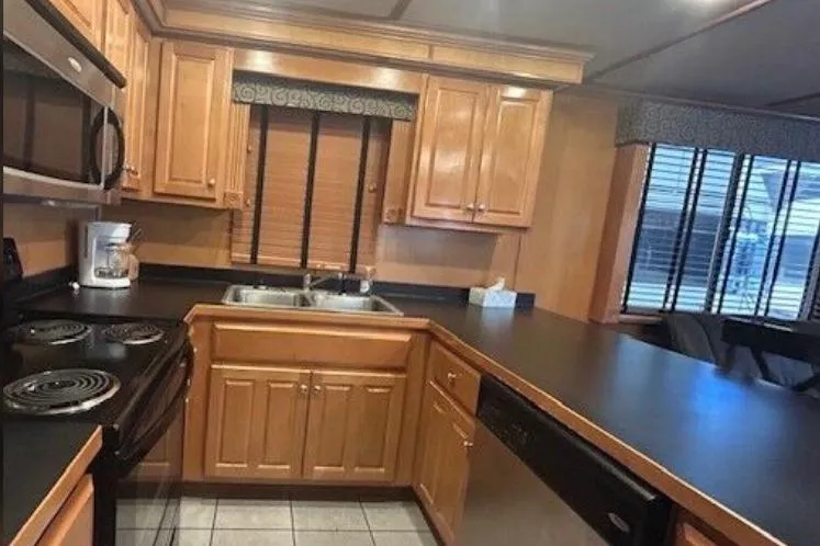 Slide: The Image of 2007 Sumerset Lakeview HD kitchen with wooden cabinets and modern appliances. - 19