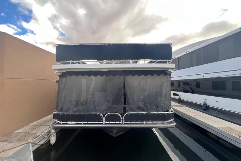 Slide: The Image of Front view of a 2007 Lakeview 62 HD houseboat docked under cloudy skies. - 2