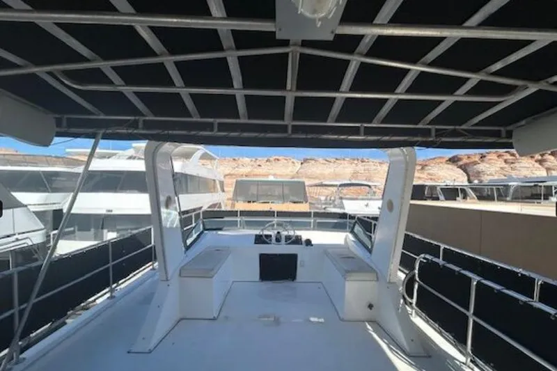 Slide: The Image of 2007 Sumerset Lakeview HD houseboat deck with canopy, surrounded by scenic rock formations. - 34