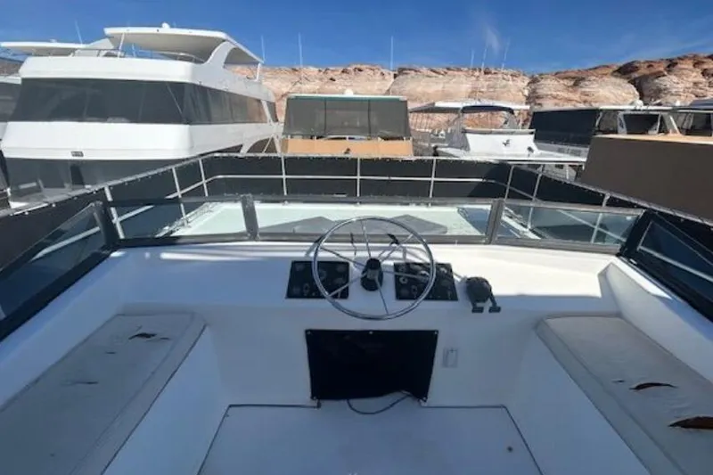 Slide: The Image of 2007 Sumerset Lakeview HD houseboat helm with scenic marina backdrop. - 35