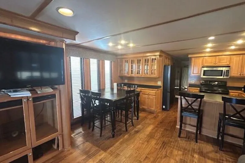 Slide: The Image of 2007 Sumerset Lakeview HD interior with wooden cabinets, dining area, and modern kitchen appliances. - 11