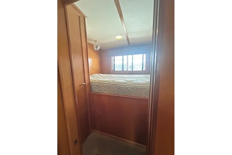 Slide: The Image of 2007 Sumerset Lakeview HD houseboat interior with cozy bunk bed and wooden paneling. - 23