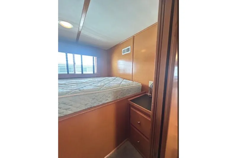 Slide: The Image of 2007 Sumerset Lakeview HD bedroom with mattress, wooden walls, and storage drawers. - 24
