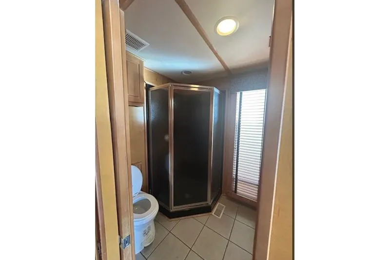 Slide: The Image of Bathroom interior of 2007 Sumerset Lakeview HD houseboat with shower and toilet. - 26