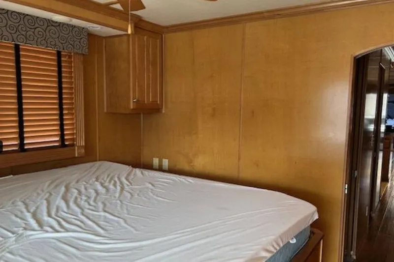 Slide: The Image of Bedroom interior of 2007 Sumerset Lakeview HD houseboat with wooden walls and blinds. - 27