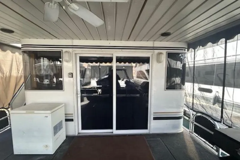 Slide: The Image of 2007 Sumerset Lakeview HD houseboat interior with sliding glass doors and ceiling fan. - 6