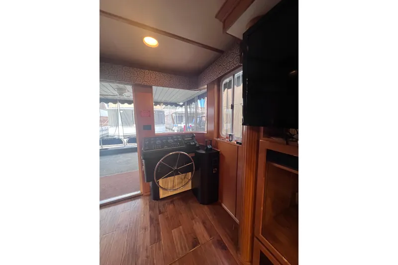 Slide: The Image of 2007 Sumerset Lakeview HD houseboat interior with steering wheel and control panel. - 9