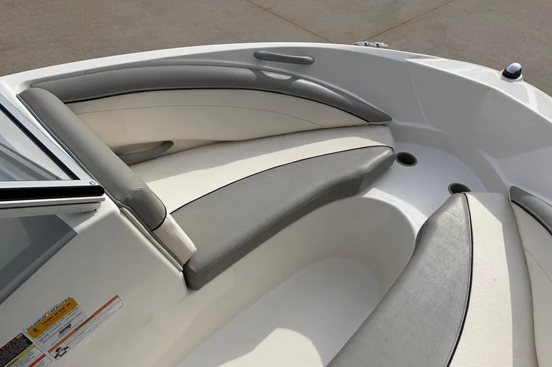Slide: The Image of 2011 Bayliner 185 boat interior with gray and white cushioned seating. - 12