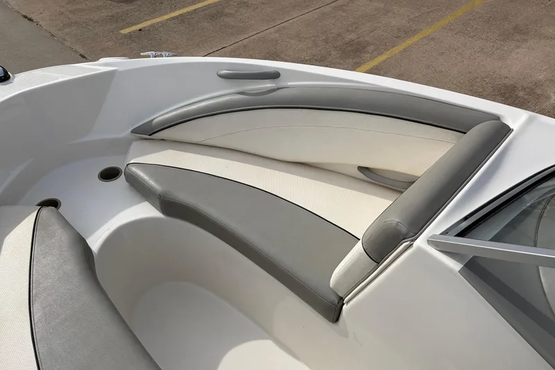 Slide: The Image of 2011 Bayliner 185 boat interior with gray and white cushioned seating. - 13