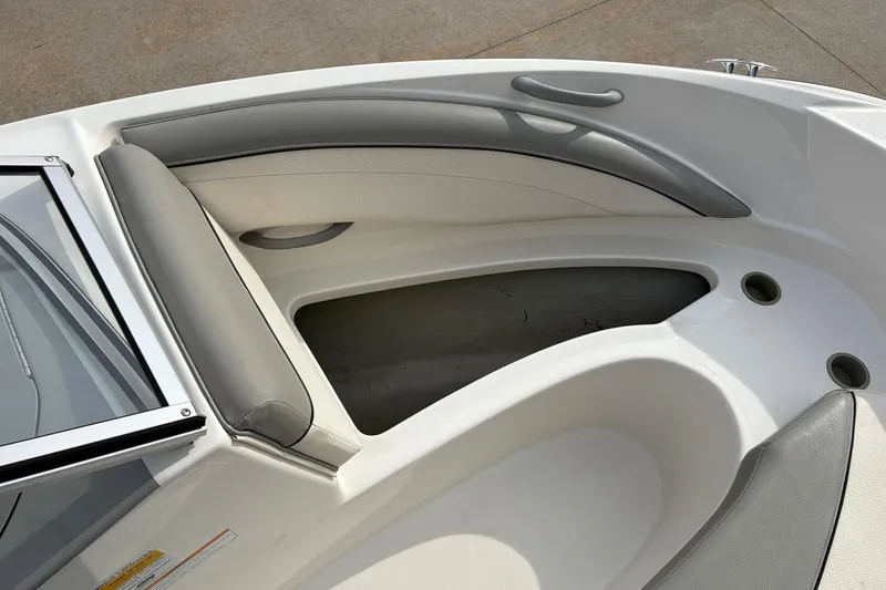 Slide: The Image of 2011 Bayliner 185 boat interior with gray seating and storage compartments. - 14