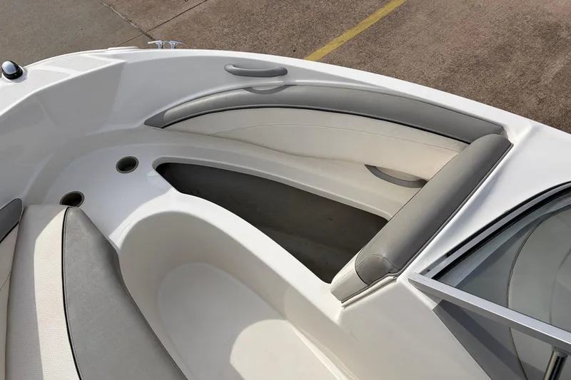 Slide: The Image of 2011 Bayliner 185 boat interior with gray and white seating. - 15