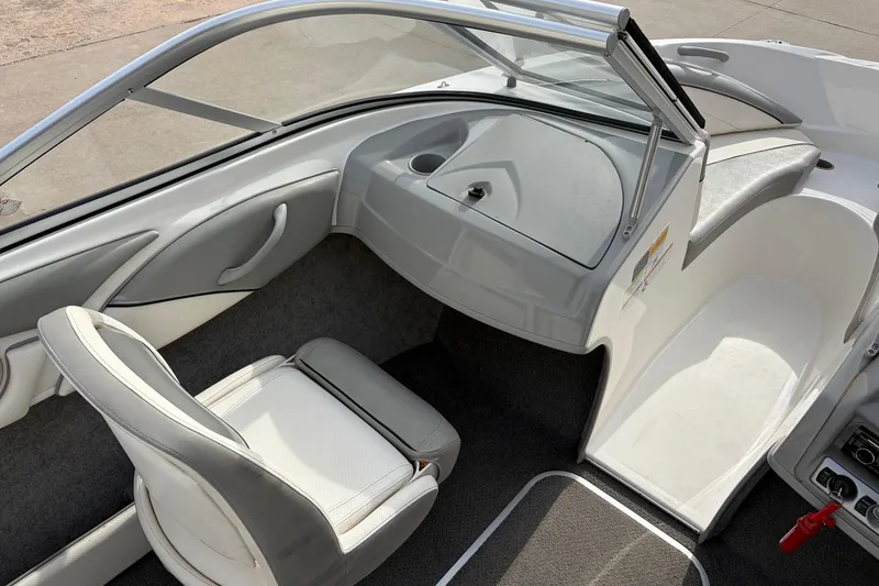 Slide: The Image of Interior of a 2011 Bayliner 185 boat, featuring seating and dashboard. - 17