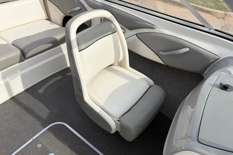 Slide: The Image of Interior of a 2011 Bayliner 185 boat with white and gray seating. - 19