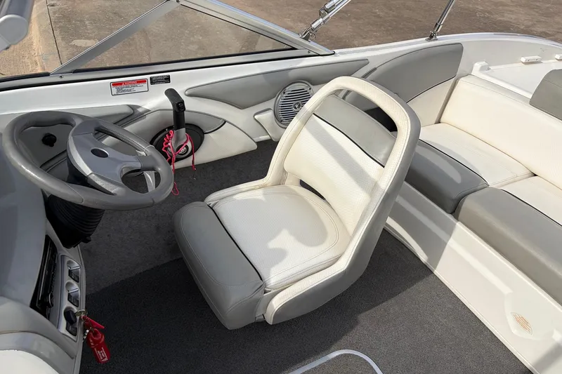 Slide: The Image of Interior of a 2011 Bayliner 185 boat, featuring steering wheel and seating. - 21