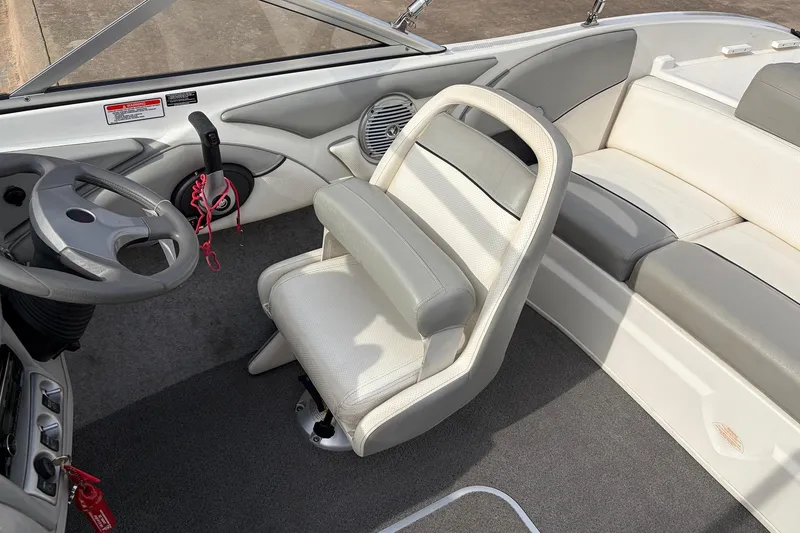 Slide: The Image of Interior of a 2011 Bayliner 185 boat with steering wheel and seating. - 22