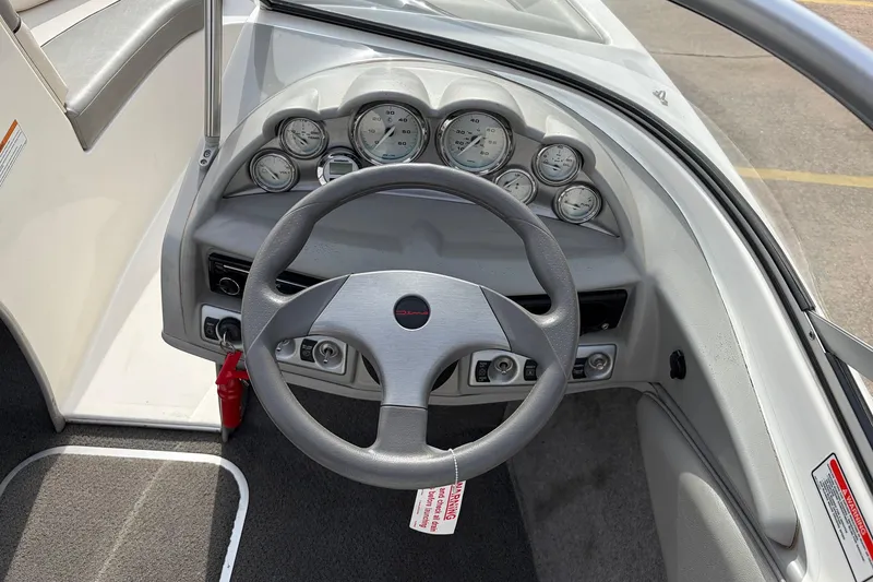 Slide: The Image of 2011 Bayliner 185 boat dashboard with steering wheel and gauges. - 23