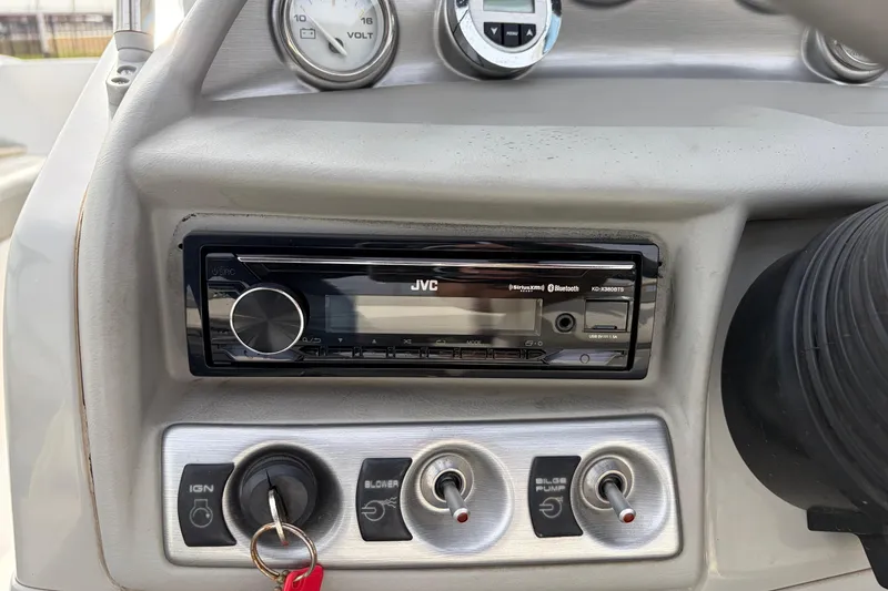 Slide: The Image of Dashboard of a 2011 Bayliner 185 boat with JVC stereo and control switches. - 26