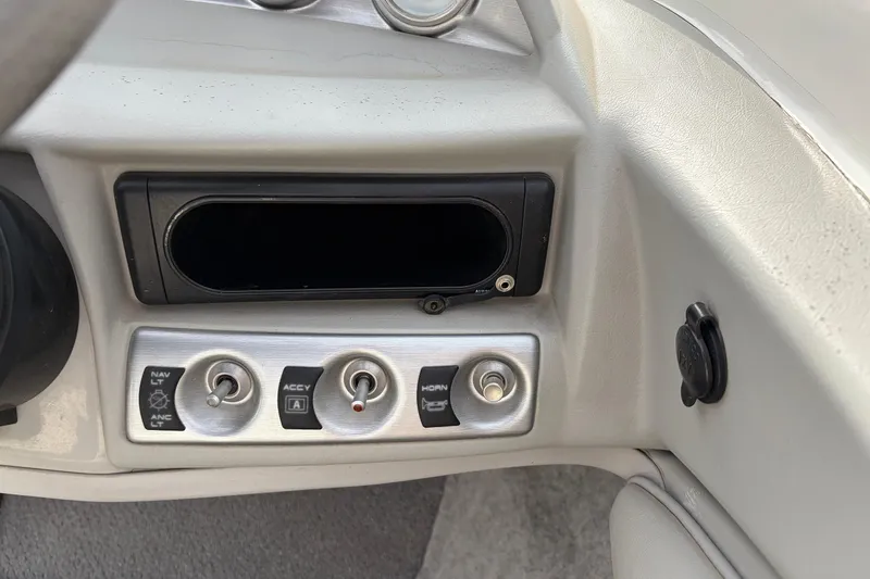 Slide: The Image of Dashboard controls of a 2011 Bayliner 185 boat, featuring switches and a panel. - 27