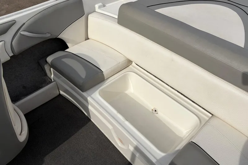 Slide: The Image of 2011 Bayliner 185 boat interior with white and gray seating and storage compartment. - 31