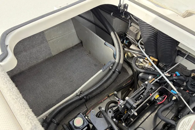 Slide: The Image of Engine compartment of a 2011 Bayliner 185 boat, showing hoses and mechanical components. - 36