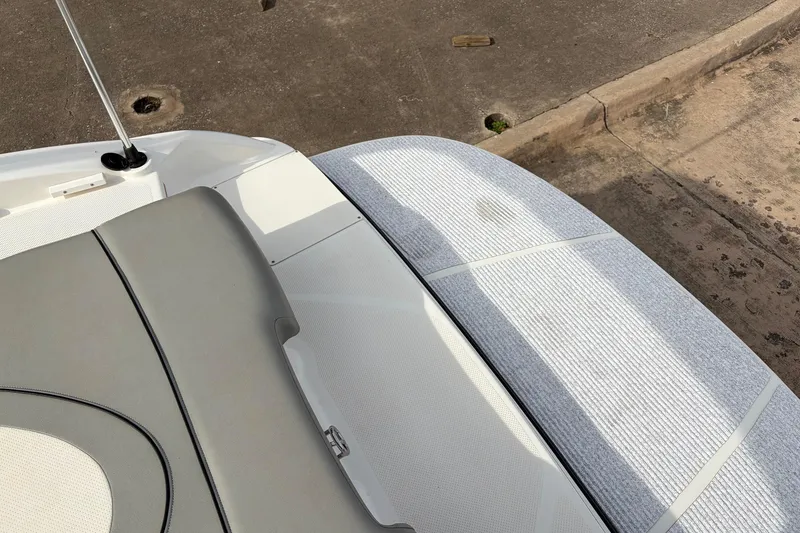 Slide: The Image of 2011 Bayliner 185 boat interior with gray seating and textured flooring. - 38