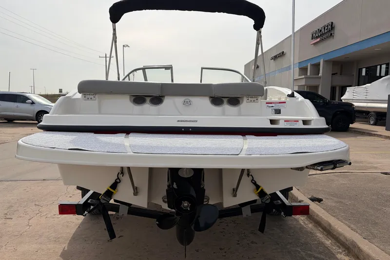 Slide: The Image of 2011 Bayliner 185 boat rear view at dealership, showcasing swim platform and outboard motor. - 6