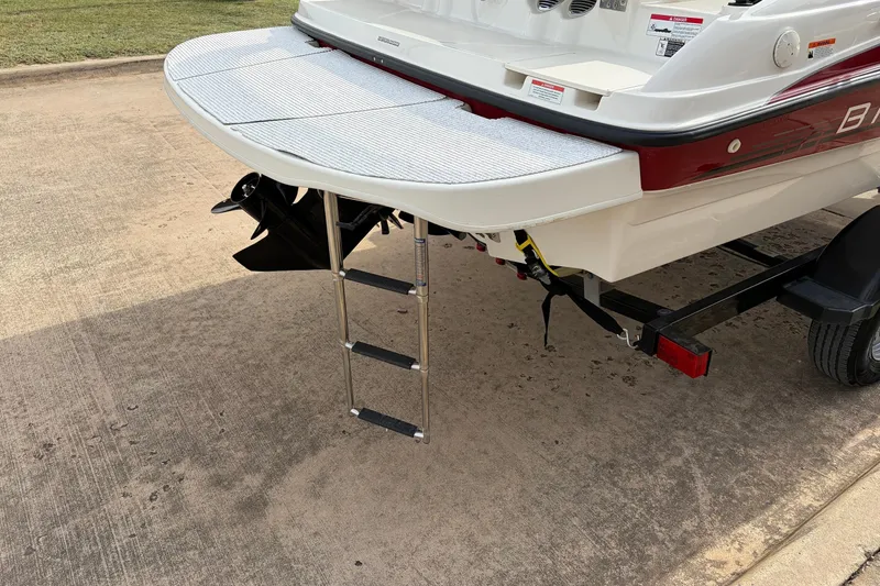 Slide: The Image of 2011 Bayliner 185 boat with extended swim platform and ladder on trailer. - 9
