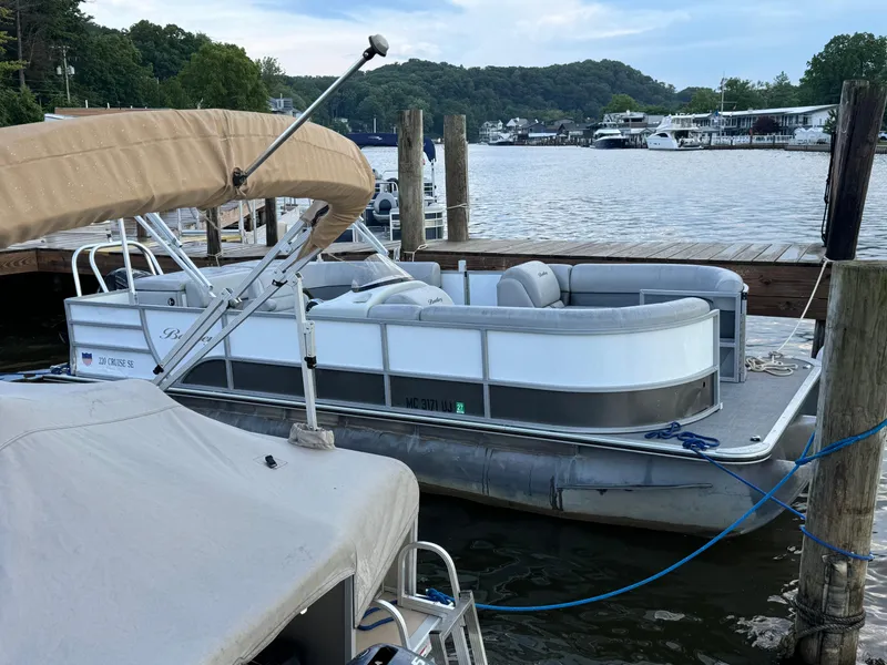 Slide: The Image of 2019 Bentley Pontoons 220/223 Cruise docked by a scenic waterfront. - 4