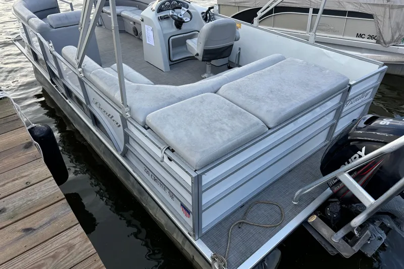Slide: The Image of 2019 Bentley Pontoons 220/223 Cruise boat docked with cushioned seating and steering console. - 5