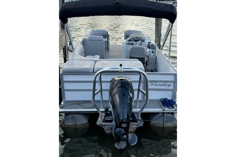 Slide: The Image of 2019 Bentley Pontoons 220/223 Cruise boat docked, rear view with motor and seating. - 6