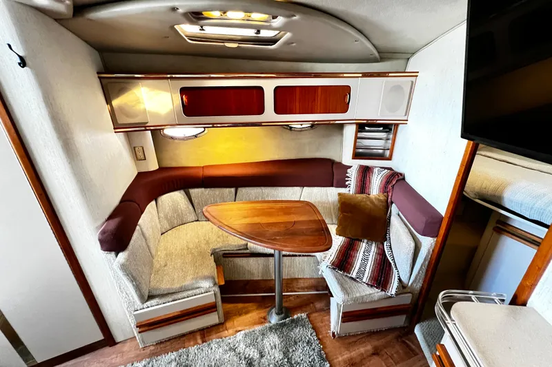 Slide: The Image of 1989 Cruisers Yachts 3670 Esprit interior with cozy seating and wooden table. - 17