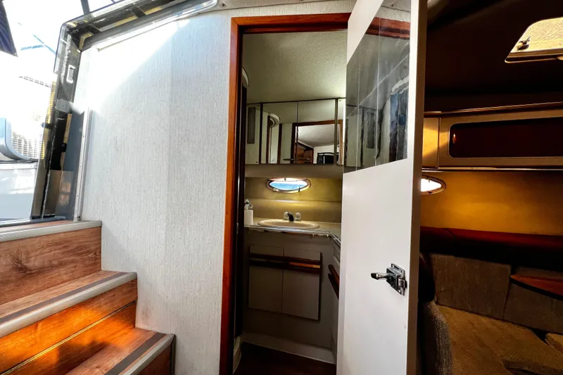 Slide: The Image of 1989 Cruisers Yachts 3670 Esprit interior with stairs, bathroom, and cozy cabin. - 21