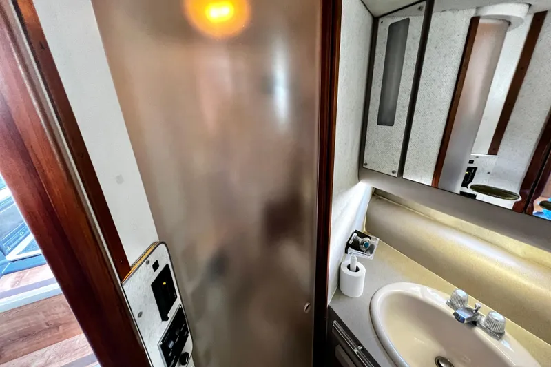 Slide: The Image of 1989 Cruisers Yachts 3670 Esprit bathroom with sink, mirror, and frosted door. - 24