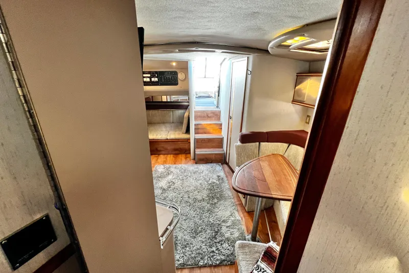 Slide: The Image of Interior of 1989 Cruisers Yachts 3670 Esprit with cozy seating and wooden accents. - 26