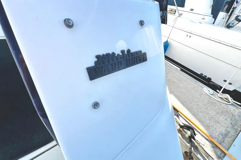 Slide: The Image of 1989 Cruisers Yachts 3670 Esprit docked, featuring "Warp Drive" emblem. - 6