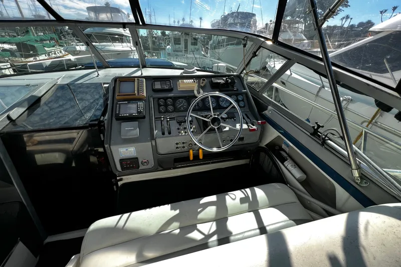 Slide: The Image of 1989 Cruisers Yachts 3670 Esprit helm with steering wheel and navigation equipment. - 9