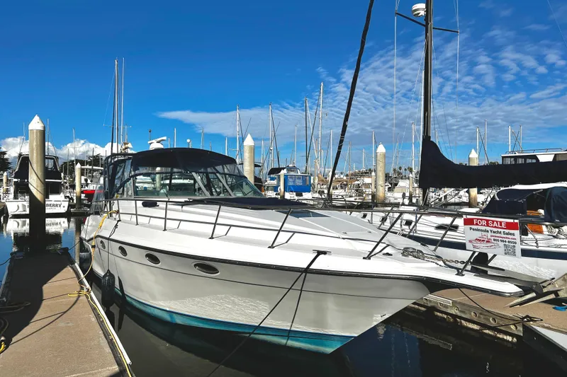 Slide: The Image of 1989 Cruisers Yachts 3670 Esprit for sale at marina, clear blue sky. - 0