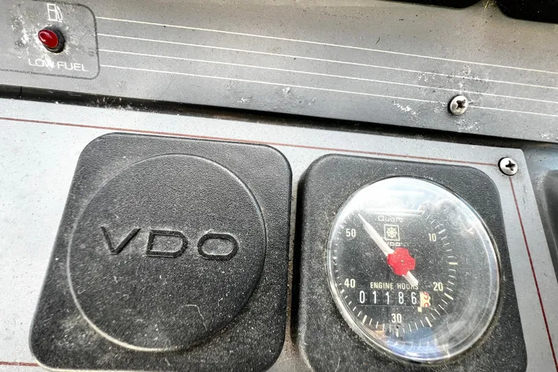 Slide: The Image of 1989 Cruisers Yachts 3670 Esprit dashboard with VDO gauge and low fuel indicator. - 11