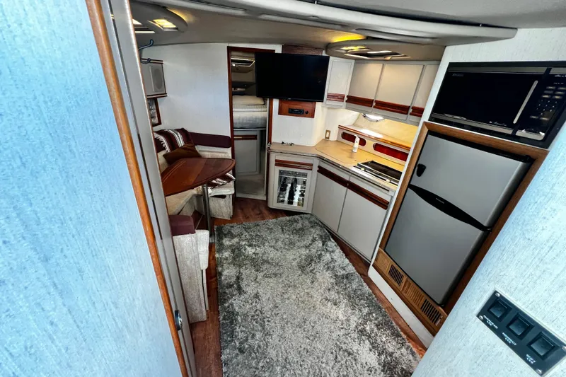 Slide: The Image of 1989 Cruisers Yachts 3670 Esprit interior with kitchen, seating, and modern amenities. - 13