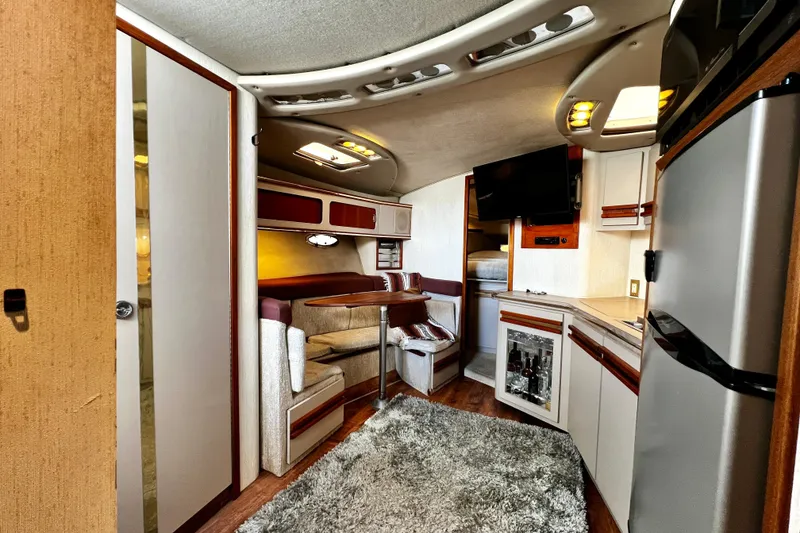 Slide: The Image of 1989 Cruisers Yachts 3670 Esprit interior with cozy seating, kitchenette, and modern amenities. - 14