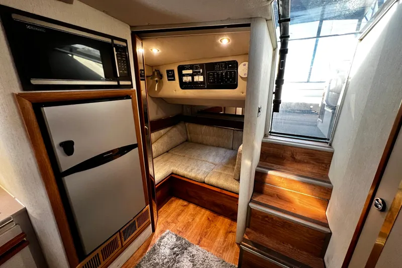 Slide: The Image of 1989 Cruisers Yachts 3670 Esprit interior with kitchenette, seating, and stairs. - 19