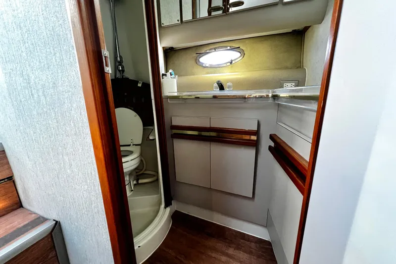 Slide: The Image of 1989 Cruisers Yachts 3670 Esprit bathroom with sink, toilet, and wooden accents. - 22